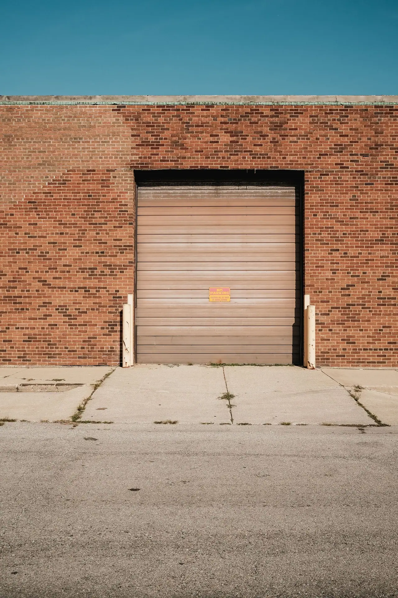 Brick commercial building with a metal overhead door